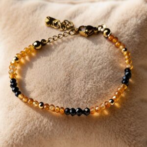Bracelet artisanal "Zénéra Sombre (IId)" - Zircon orange & tourmaline noire - chainette dorée en acier inoxydable